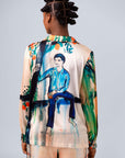 Back view of a model wearing a colorful shirt vest featuring a painting of a boy, part of the Les Orangers collection.